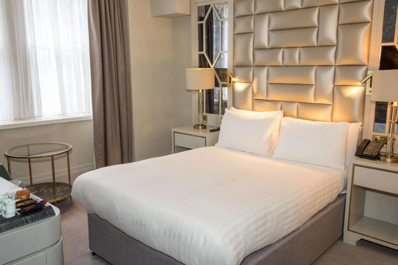 a hotel room with a large bed and a desk at Henrietta House, a member of Radisson Individuals in Bath